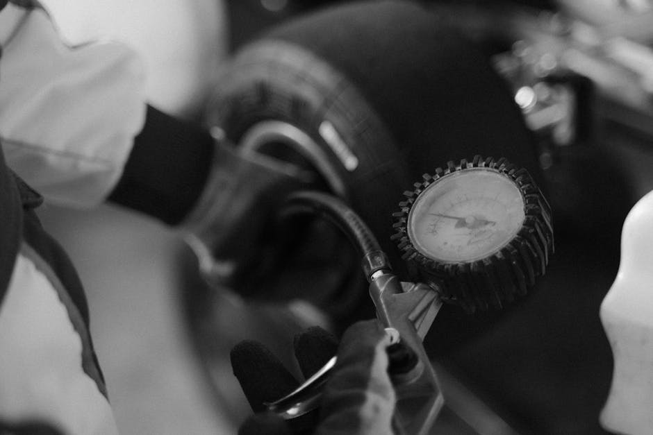 Technician checking tire pressure and wheel alignment
